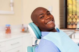 African American man smiling in a dentist chair