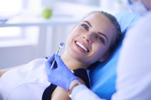 Young female patient pretty smile being examined